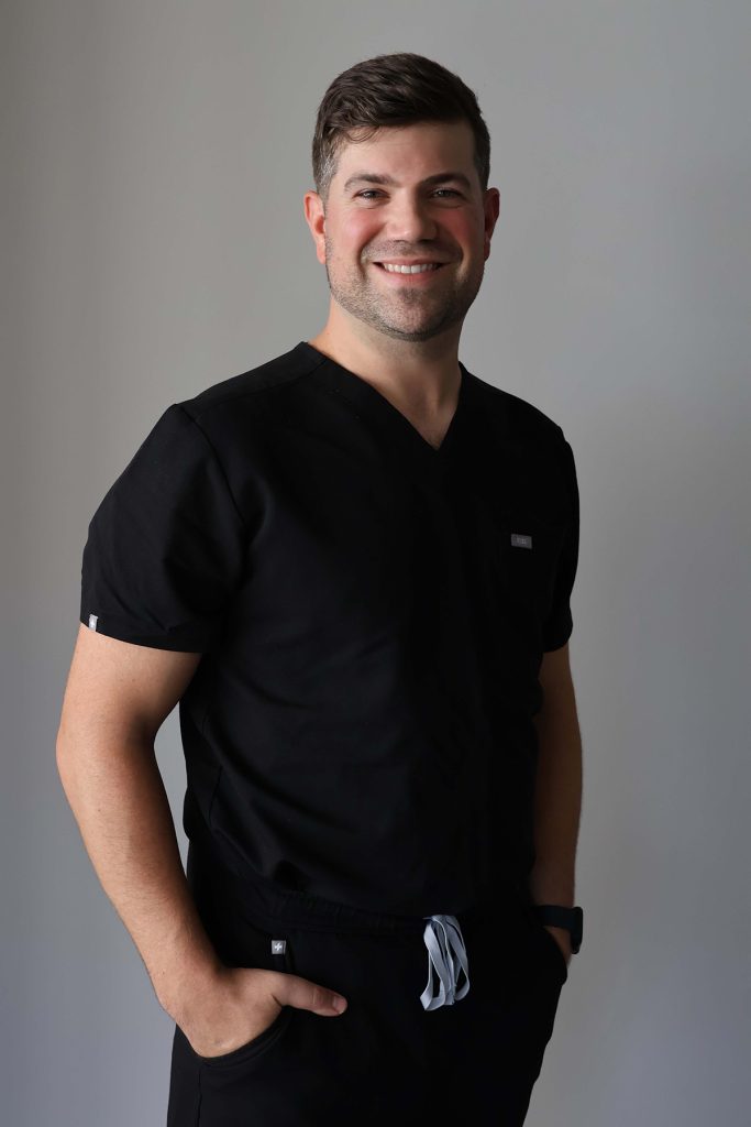 Dr. Randall wearing scrubs, showcasing his expertise and professionalism as a facial plastic surgeon in Morristown, NJ.