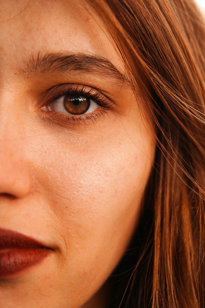 Close-up of half of a woman's face showing one beautiful eye with a piercing gaze