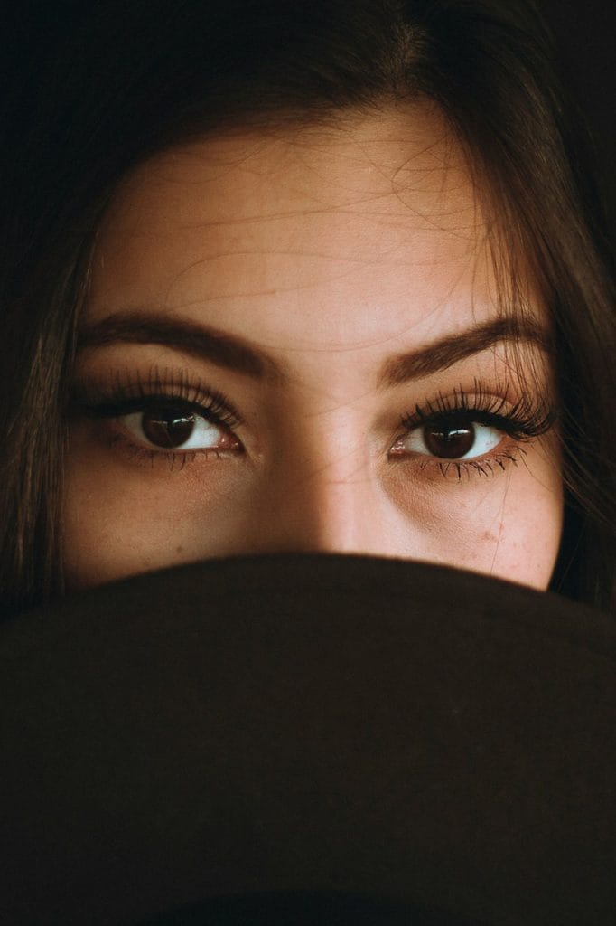 Close-up of a beautiful woman with a face covering, highlighting her youthful eyes