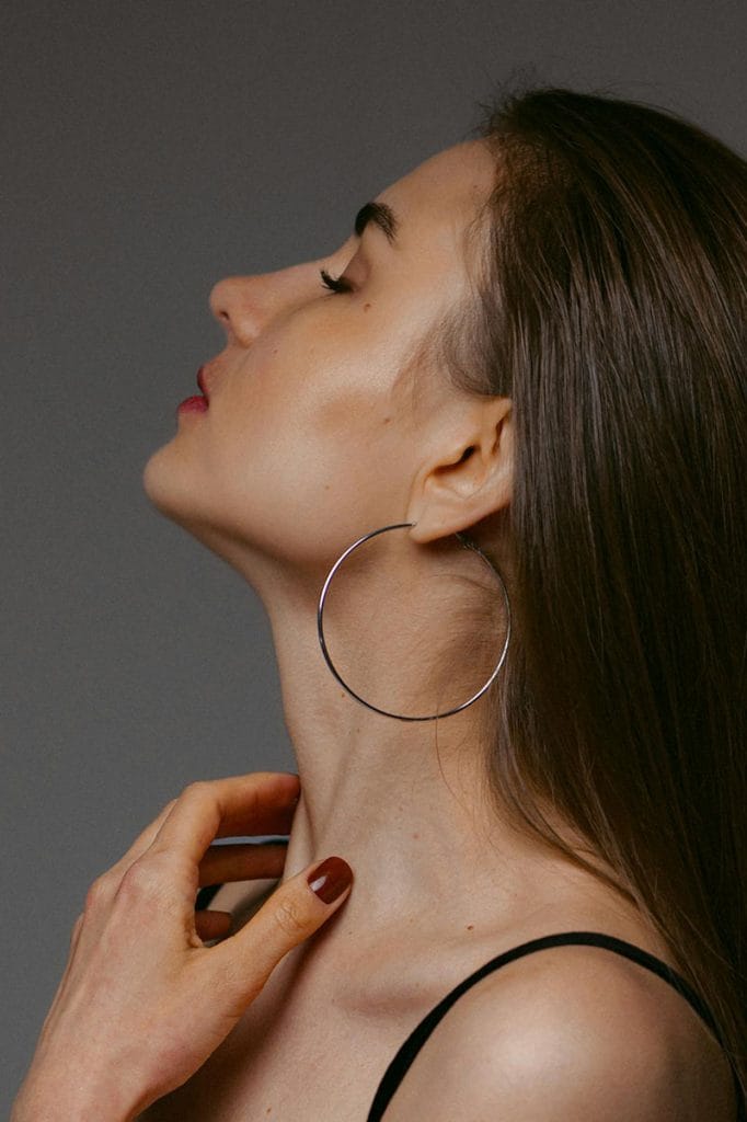A beautiful woman, showcasing her neckline- creating an ideal for plastic surgery procedures by Dr. Randall in Morritown, NJ
